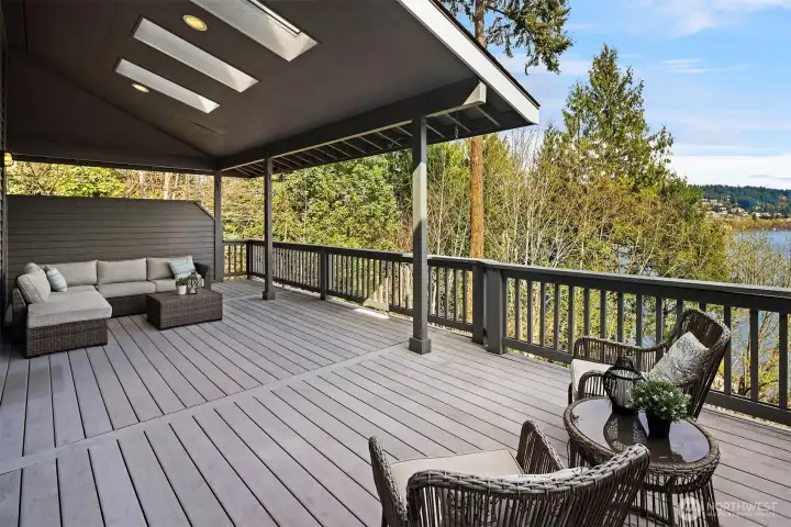 Partially covered, with extra covered storage space to the left behind the couch. Newer composition deck and freshly painted exterior