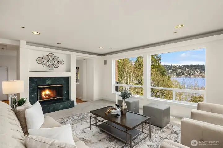 Large living area with picture windows, fill the home with light and it feels like you can almost touch the lake.