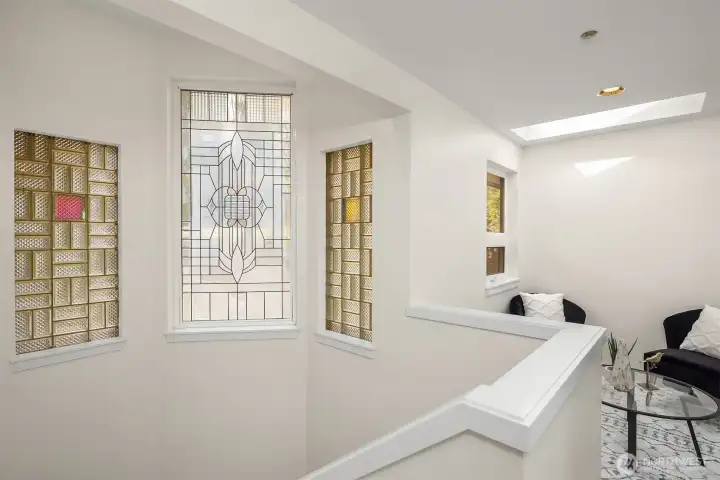 The architectural windows bring charm and character. There's a loft style sitting area upstairs