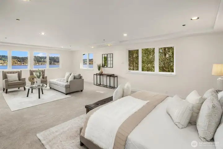 The primary suite is huge, with jaw droppingly gorgeous lake views. With a king sized bed, and a large sitting area, there's still oodles of room. Not shown is two enormous primary closets, and ensuite bathroom.