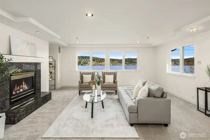 The sitting area in the main primary suite with a fireplace for comfort and ambiance. This room is plenty big enough to divide into two rooms to give three bedrooms upstairs. Or keep as is for a the most incredible private suite.
