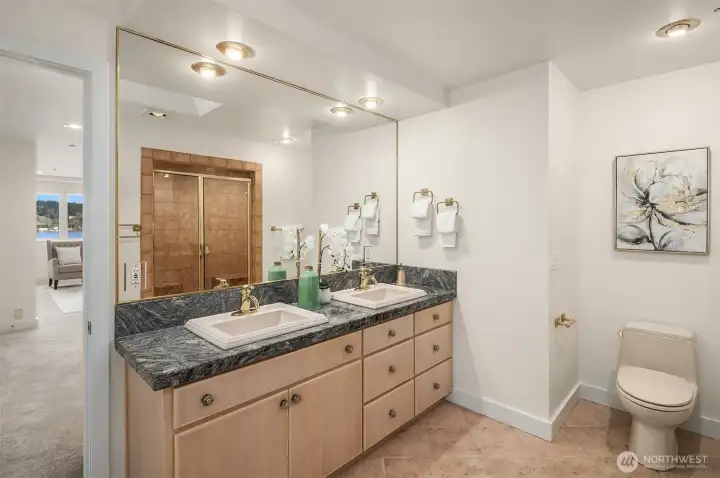 One of two ensuite bathrooms upstairs. Double vanities, huge walk in shower, and a very large second walk-in closet finish off the primary suite bathroom