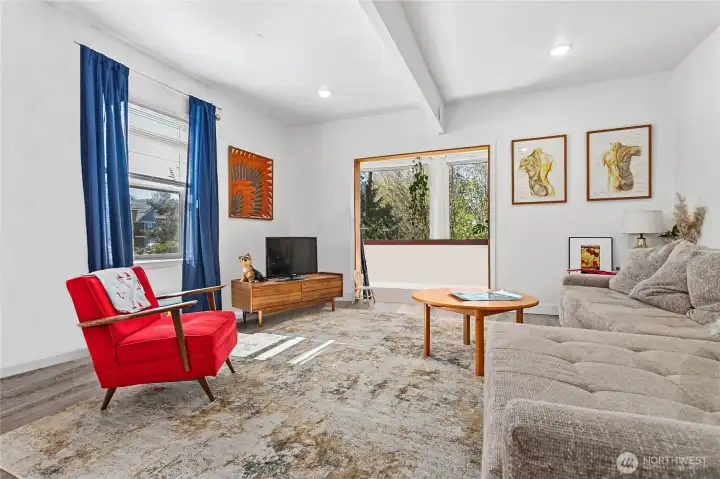 Main floor with high ceilings, open floor plan and big windows creates a welcoming and inviting space.