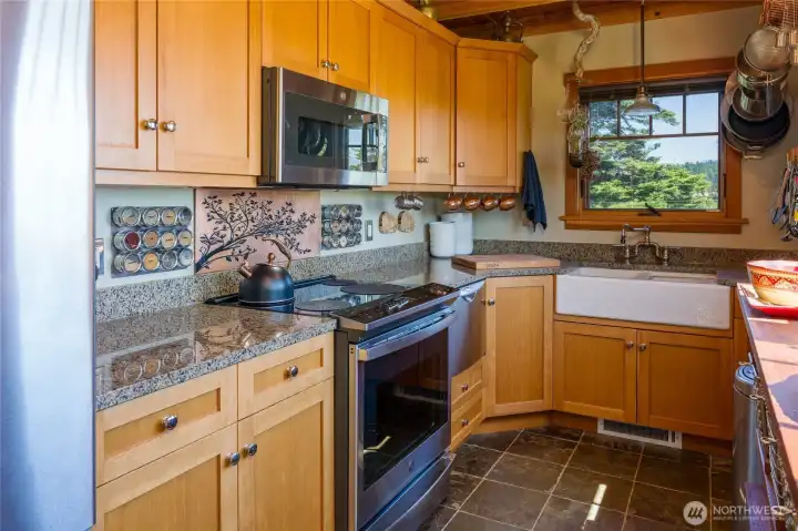 The kitchen boasts a GE Profile induction stove, Fisher Paykel drawer dishwasher and farm sink. The kitchen boasts a GE Profile induction stove, Fisher Paykel drawer dishwasher and farm sink.