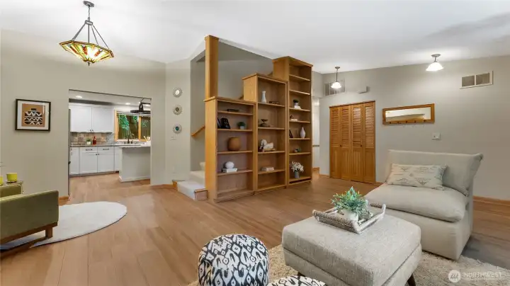 A view from the living room toward the kitchen and stairs to the second floor.