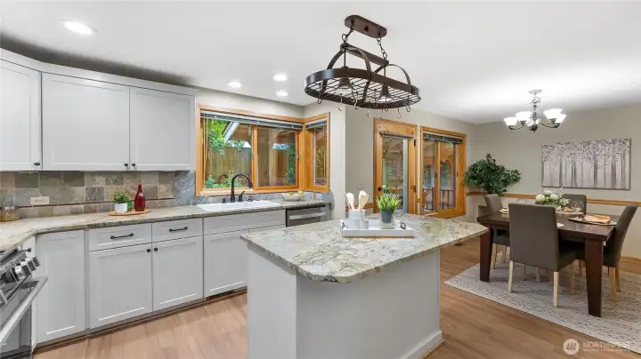 The kitchen offers suede finished granite counters with slate backsplash with feature "haystack" stones inserted throughout the design.