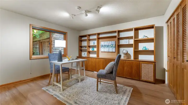 The bedroom on the main floor offers built-in shelving and storage cabinets. There is a pocket door to the 3/4 bath on the main floor.
