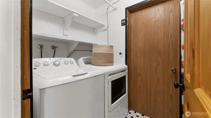 The laundry room and utility area are located off the hall. A door leads to the garage from here.