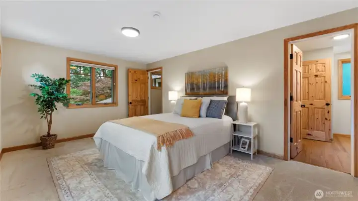 A view of the primary bedroom in to the attached bathroom.