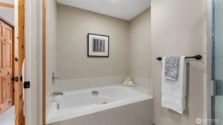 The soaking tub in the primary bathroom offers a respite at the end of the day.