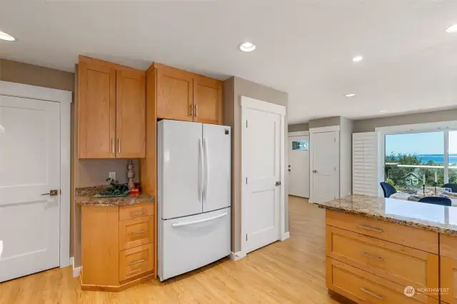 To the right of fridge is stairs to the lower level.