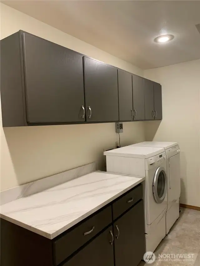 Laundry Room- beautiful cabinets and countertop.