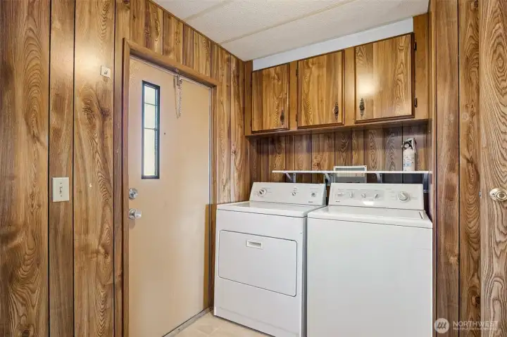 Laundry room w/ shelf and cabinets.