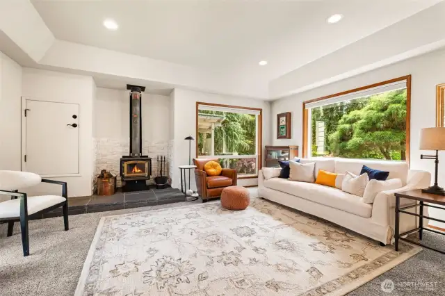 Cozy up in this formal living room with a wood-burning fireplace and passthrough for firewood.