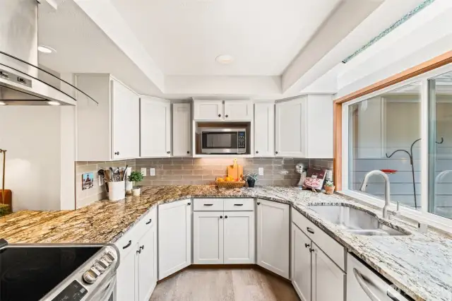Bright and updated kitchen with granite countertops and ample cabinetry.
