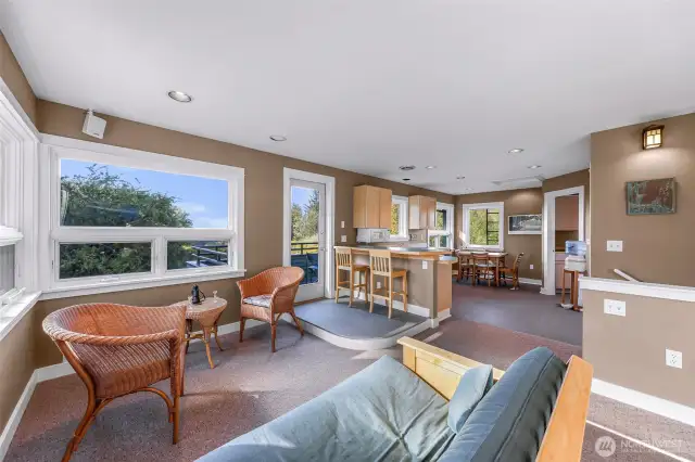 Upstairs open concept living, kitchen, and dining room with wonderfully elevated views of the surrounding natural habitat.