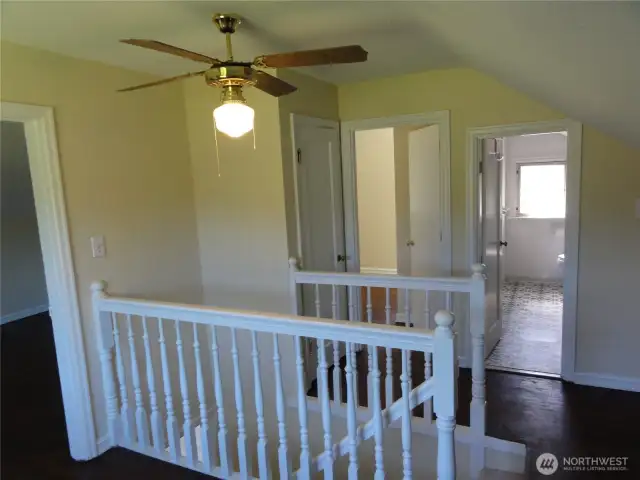 Top of stairs on 2nd floor. Restored hardwood floors!