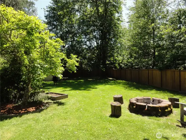 More of back yard with raised planter boxes. Fully fenced back yard.