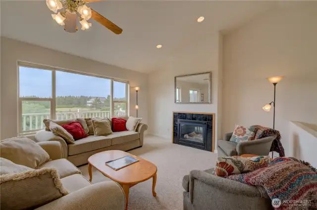 Upper level living area with gas fireplace and ocean view. This condo is fully furnished and move in ready.