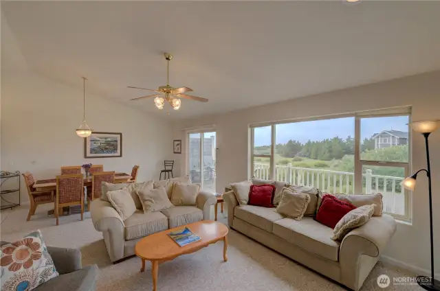 From the living room looking to the dining room and north facing deck with ocean view.