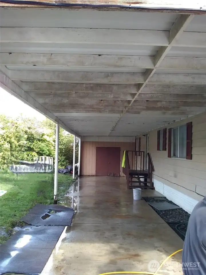 Two car carport with storage at the end.