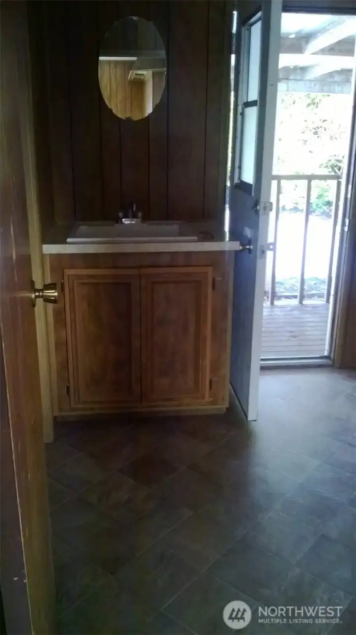 Older photo of laundry sink and back door.