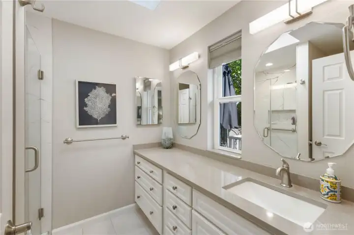 Recently updated bathroom with newer counters, cabinets, lighting and shower