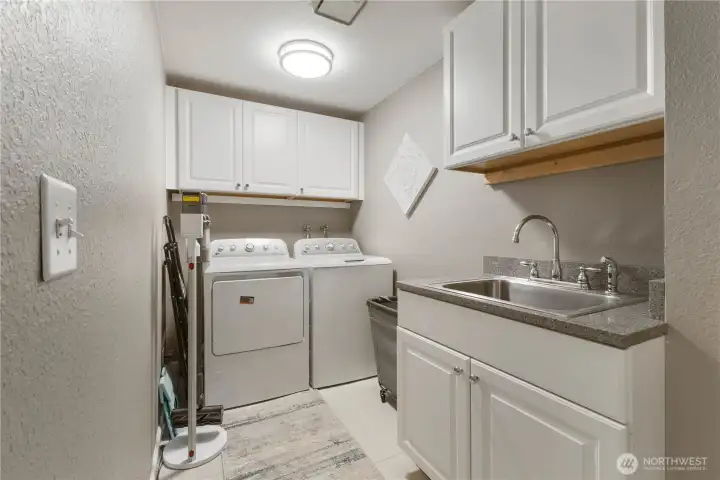 Check out this great laundry space with sinks and cabinets.