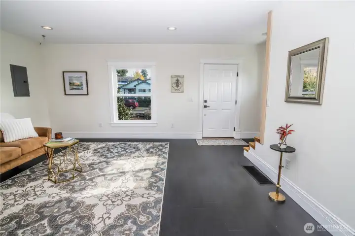 Front door and large, well-lit living room.