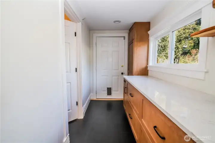 Walk-in pantry leads to 3/4 bath and back door.  Tankless water heater in closet near door.