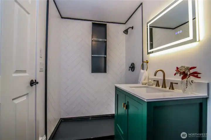 Big shower with niche shelves.  Switch-wired lighted mirror.