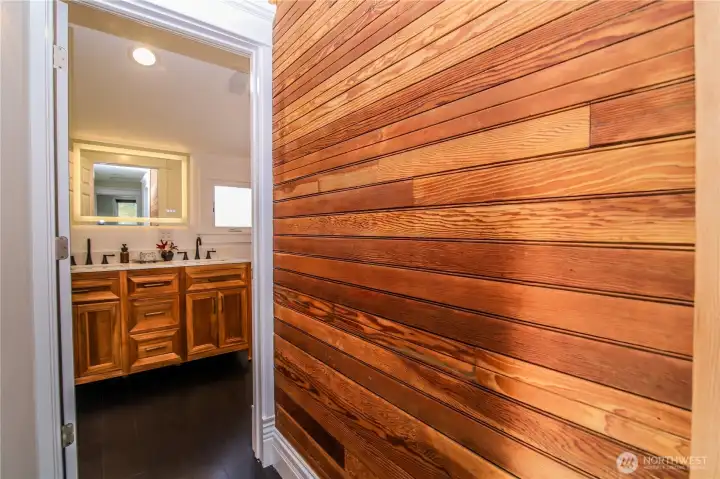 Hallway to upstairs full bath, original paneling refinished by owners.