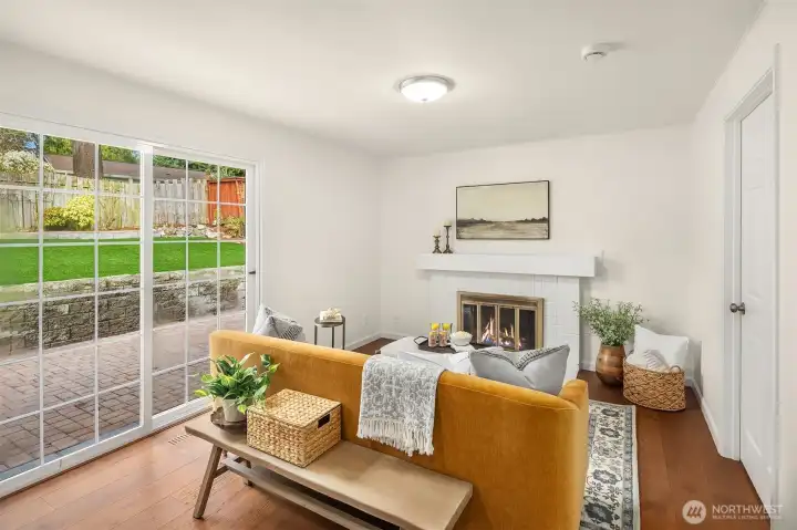 Adorable second living room just off the kitchen with a real wood fire, and sliding doors to the back patio. In total there are three sets of doors to the patio providing indoor outdoor living throughout the warmer summer months.
