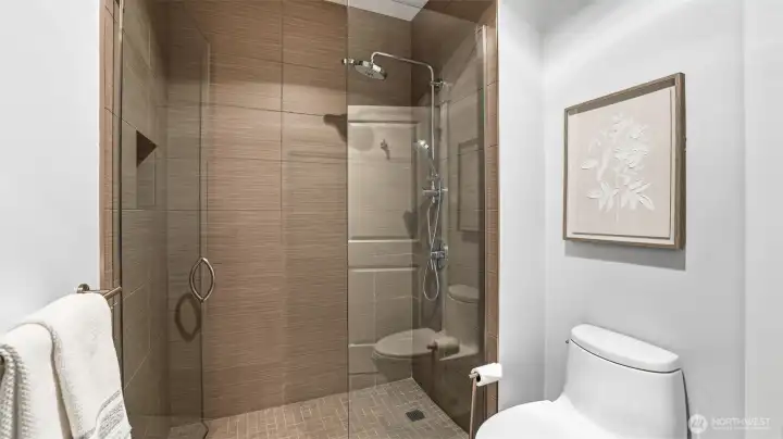 Primary suite attached bath with frameless walk-in shower