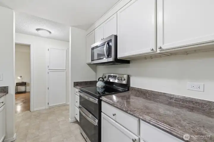 Sleek stainless steel appliances and ample storage.