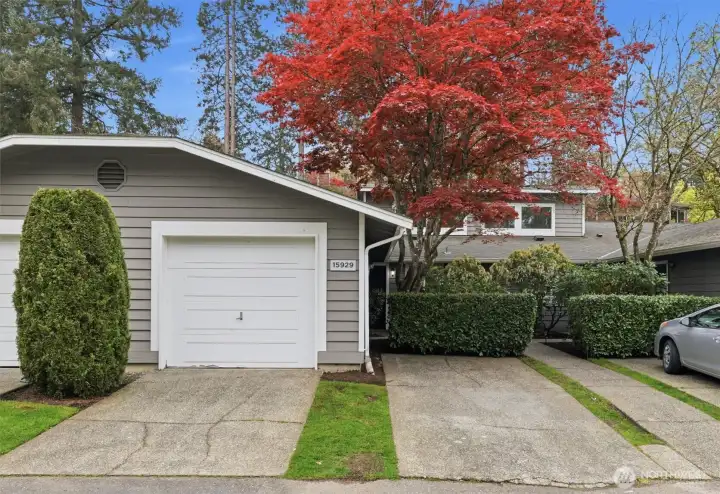 Secure, dedicated parking includes a private one-car garage and additional assigned space, complemented by a newly installed EV charger