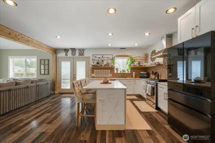 Inviting kitchen with farmhouse detail and open shelving. Perfect for entertaining!