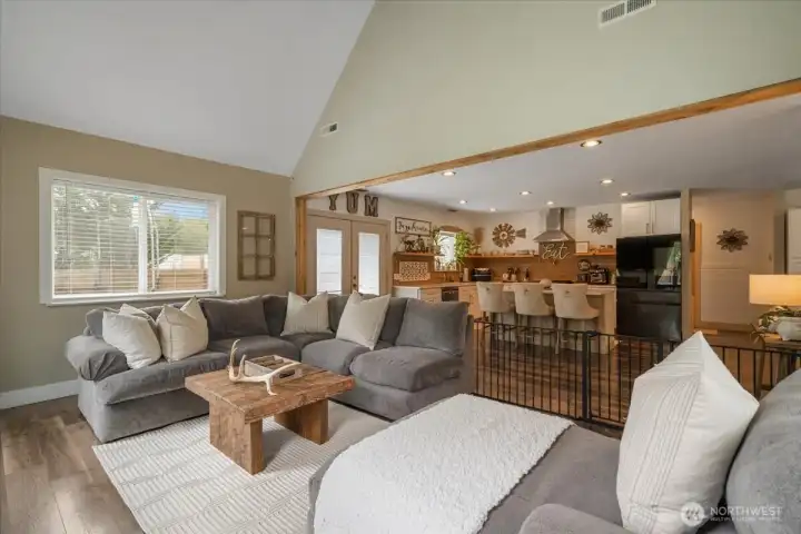 Spacious living room filled with natural light and vaulted ceilings