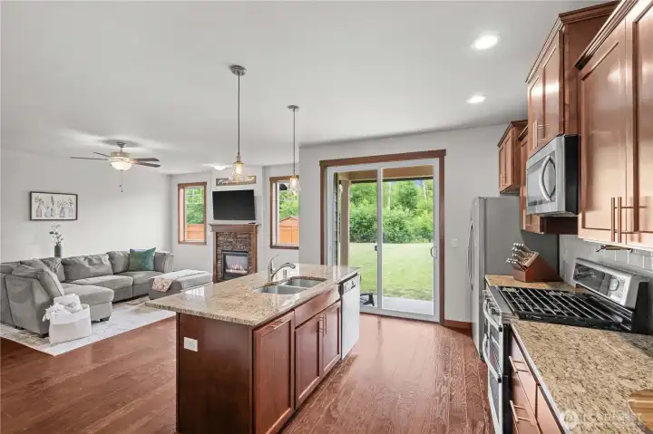 Open-concept kitchen and living area with backyard access in a 5-bedroom Stanwood WA home Open-concept kitchen and living area with backyard access in a 5-bedroom Stanwood WA home