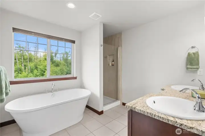 Luxury primary bathroom with soaking tub and walk-in shower in newer Stanwood WA home Luxury primary bathroom with soaking tub and walk-in shower in newer Stanwood WA home