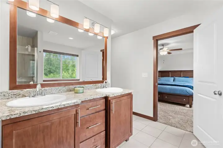 Dual-sink vanity in primary bathroom offering functional space for busy households Dual-sink vanity in primary bathroom offering functional space for busy households