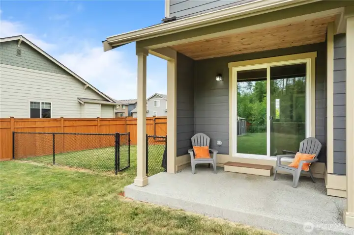 Covered patio overlooking spacious backyard in Stanwood WA home with outdoor entertaining space Covered patio overlooking spacious backyard in Stanwood WA home with outdoor entertaining space
