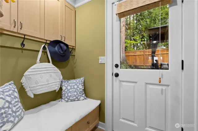 Mud room entrance to the backyard. Built in bench with storage, drawers and pull out drawers in upper cabinets.