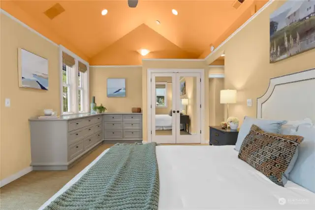 Primary suite has ceiling fans, vaulted ceilings and custom built in dressers.