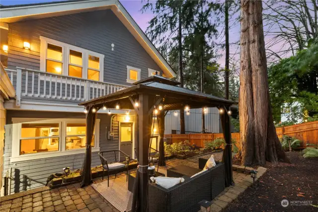 Metal roof on the gazebo with cafe lights makes for a great spot to entertain or hang outside.