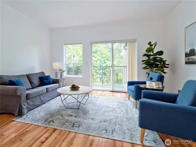 Living room with lots of natural light opens to deck