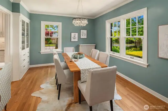 Dining room has a built-in China cabinet and looks over the lush garden.