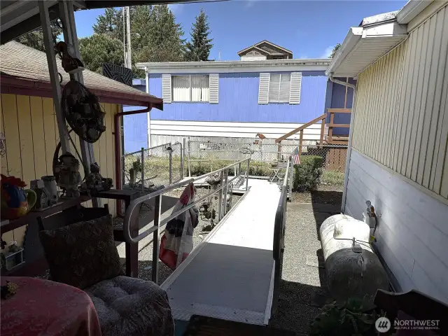 Ramp in backyard between home and 3 car garage just off your covered back porch