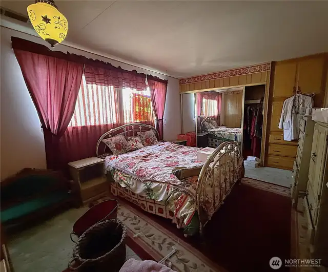 Nice sized primary bedroom with plenty of built in cabinetry and nice size double door sliding mirror closet