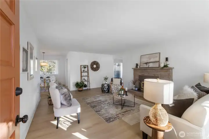 Living area with fireplace, large light-filled windwos
